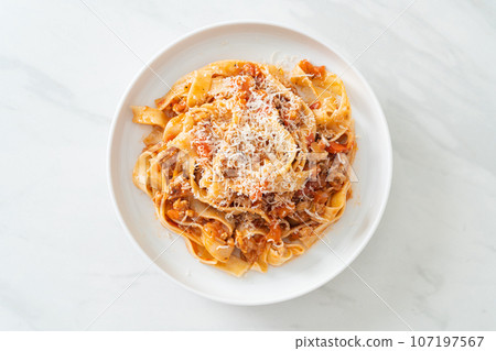 Homemade pasta fettuccine bolognese with cheese 107197567