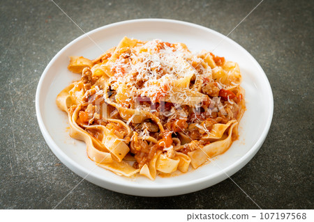 Homemade pasta fettuccine bolognese with cheese 107197568