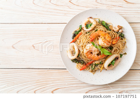 stir-fried Chinese noodle with basil, chilli, shrimps and squid stir-fried Chinese noodle with basil, chilli, shrimps and squid 107197751