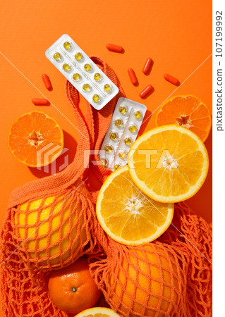 Vitamin C, in tablets, plates with oranges, on the table. Vitamin C, in tablets, plates with oranges, on the table. 107199992