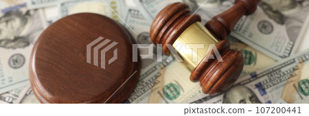 Judge gavel on dollar banknotes background. 107200441