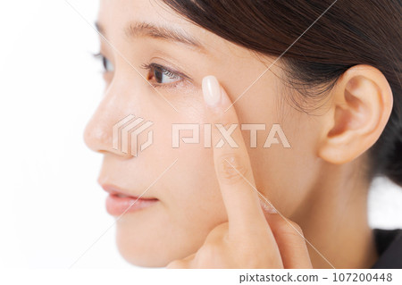 Photo of a woman in a suit pointing at her eyes Photo of a woman in a suit pointing at her eyes 107200448