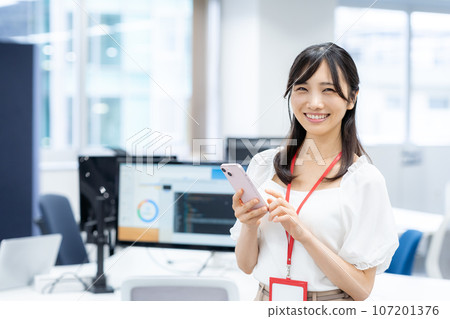 Business woman with a smartphone in the office Business woman with a smartphone in the office 107201376