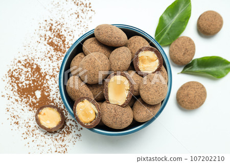 Tasty and sweet food - almonds in chocolate 107202210