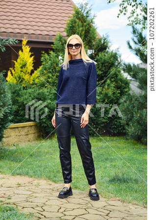 Portrait of blonde woman in trendy outfit outdoors Portrait of blonde woman in trendy outfit outdoors 107202261
