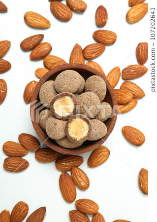 Tasty and sweet food - almonds in chocolate 107202641