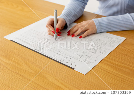 A woman writing a marriage registration A woman writing a marriage registration 107203399