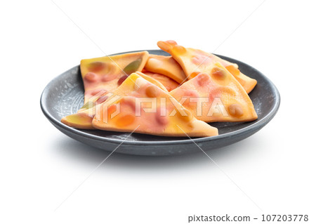 Jelly candy in the shape of a pizza isolated on white background. Jelly candy in the shape of a pizza isolated on white background. 107203778