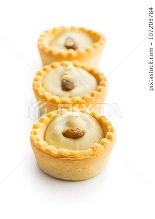 Sweet tarlets. Tasty mini tarts. Mini pie with cream isolated on white background. 107203784