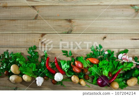 Fresh vegetables on wooden background Fresh vegetables on wooden background 107204214