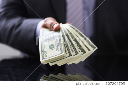 Man in suit and tie hold in arm pack of 107204705