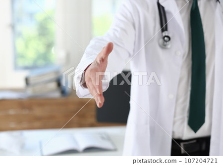 Male medicine doctor offering hand to shake 107204721