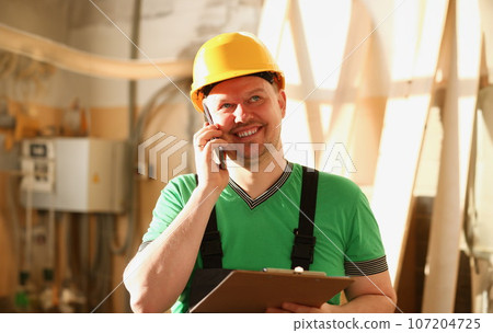 Carpenter talking on phone in hardware store 107204725