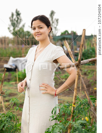 Asian woman at vegetable garden Asian woman at vegetable garden 107204804