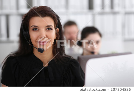 Three call centre service operators at work 107204826