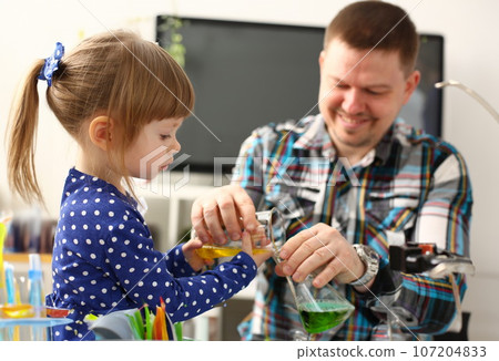 Man and little girl play with colourful liquids Man and little girl play with colourful liquids 107204833