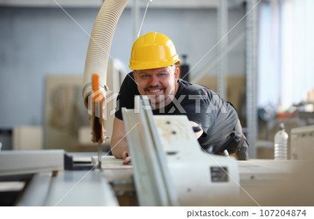 Worker using electric saw portrait 107204874