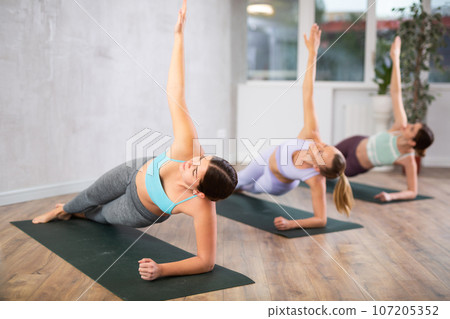 Three women doing fitness in fitness studio Three women doing fitness in fitness studio 107205352