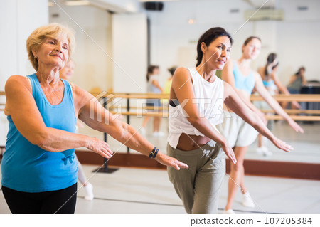 Women dancing together in studio 107205384