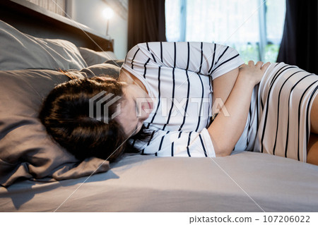 Asian middle aged woman touch belly,severe abdominal period pain,symptoms of Chocolate Cyst,Endometriosis disease,sick female having pelvic pain,acute pelvic cavity pain,Gynecology,health care concept 107206022