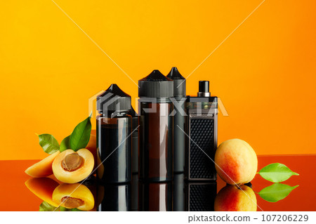 Vape smoking liquid with fruit flavor on orange background Vape smoking liquid with fruit flavor on orange background 107206229
