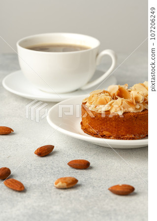 Tart pie with almond petals on plate 107206249