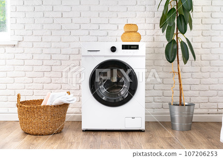 Washing machine and basket in a laundry room Washing machine and basket in a laundry room 107206253