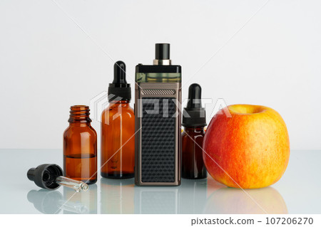 Vape liquid with apple flavor on white background Vape liquid with apple flavor on white background 107206270
