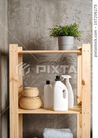 Wooden shelf with liquid detergents containers in a bathroom Wooden shelf with liquid detergents containers in a bathroom 107206278