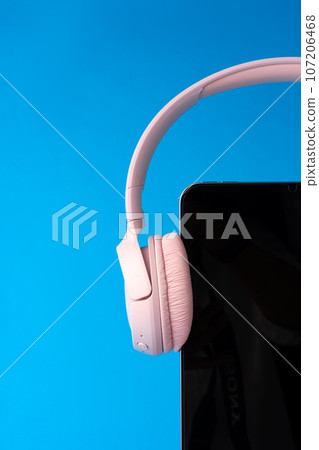 Headphones on digital tablet on blue background 107206468