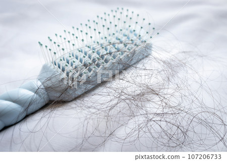 Lot of black hair falls out in the comb,damaged and broken hair by combing,hair loss problems after brushing,concept of beauty,health care and medical Lot of black hair falls out in the comb,damaged and broken hair by combing,hair loss problems after brushing,concept of beauty,health care and medical 107206733