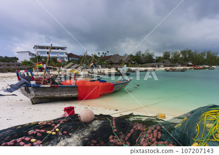 Nice view of fishing wooden boat moored on the beach Nice view of fishing wooden boat moored on the beach 107207143