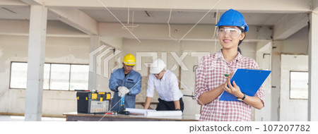 Banner Civil construction engineer team meeting on construction site with partner teamwork trust team consult together. Panorama image engineer team discuss wear hard hat construction engineer concept 107207782