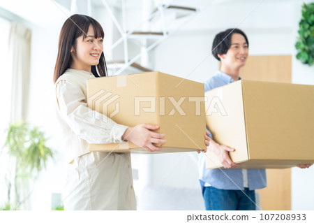 Young couple packing for moving Young couple packing for moving 107208933
