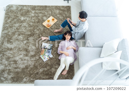 A young couple relaxing in the living room A young couple relaxing in the living room 107209022