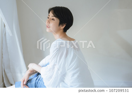Portrait of a woman relaxing indoors 107209531