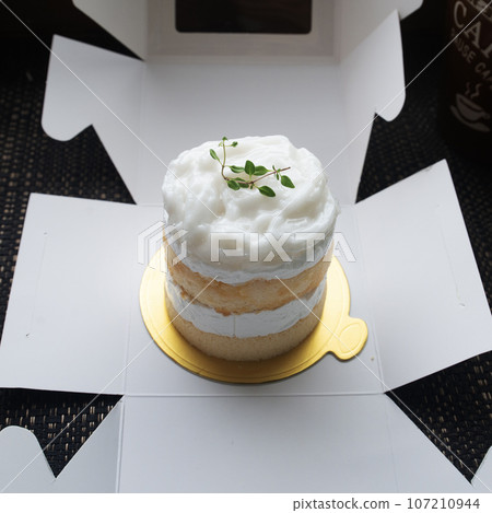Box containing delicious coconut cake was opened. Box containing delicious coconut cake was opened. 107210944