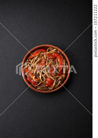 Delicious asian udon dish with vegetables, mushrooms, salt and spices Delicious asian udon dish with vegetables, mushrooms, salt and spices 107211222