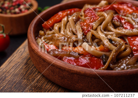Delicious asian udon dish with vegetables, mushrooms, salt and spices Delicious asian udon dish with vegetables, mushrooms, salt and spices 107211237