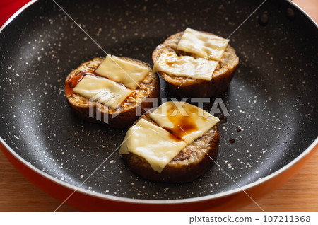 Grilled white eggplant topped with cheese and soy sauce Grilled white eggplant topped with cheese and soy sauce 107211368