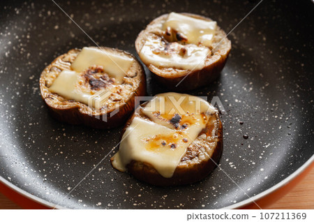 Grilled white eggplant topped with cheese and soy sauce Grilled white eggplant topped with cheese and soy sauce 107211369