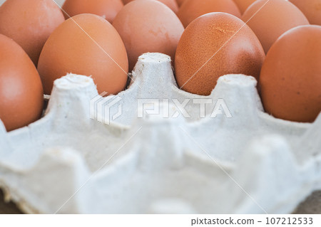 Chicken egg packaging close-up, fresh produce from farmers market, recycled packaging 107212533