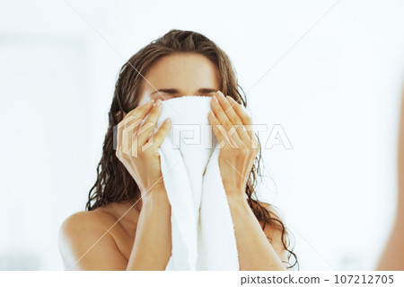 Closeup on young woman wiping with towel 107212705