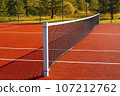 Black tennis net over a red playground outdoors 107212762