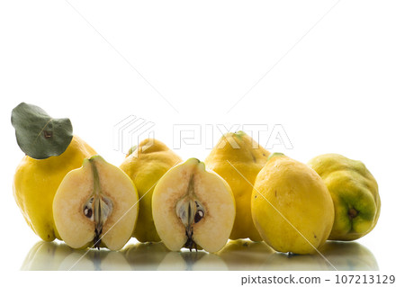 Ripe natural autumn quince on a white background. Ripe natural autumn quince on a white background. 107213129