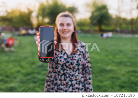 Girl use smart phone share social media news wear style stylish trendy hat over city background, Summer time, banner for mock up or photos Girl use smart phone share social media news wear style stylish trendy hat over city background, Summer time, banner for mock up or photos 107213190