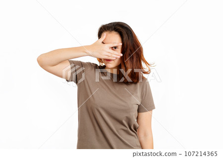 Portrait of a young Caucasian woman who covers her eye with her hand. White background. The concept of insecurity and emotional problems 107214365