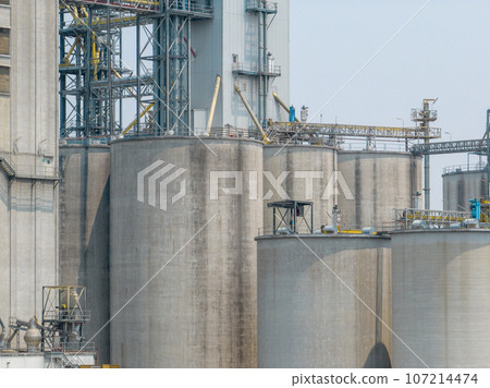 Animal feed factory. Agricultural silos, grain storage silos. Agriculture industry. Rural agribusiness. Grain storage innovation. Agricultural silos at animal feed factory. Sustainable farming. 107214474