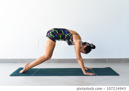 Stretching exercises yoga with ukrainian woman making it indoor Stretching exercises yoga with ukrainian woman making it indoor 107214943