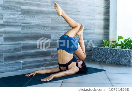 plow pose variation or halasana yoga with ukrainian woman making it indoors plow pose variation or halasana yoga with ukrainian woman making it indoors 107214968